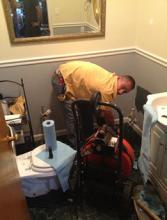 plumber clears a toilet drain in Santa Cruz